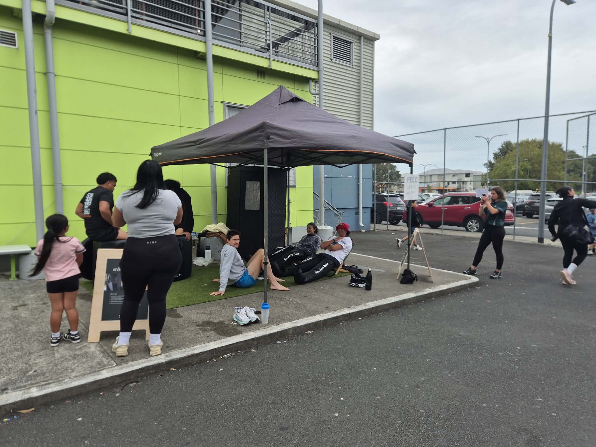 The At Home Recovery pop-up tent with ice baths and a sauna at a sports event