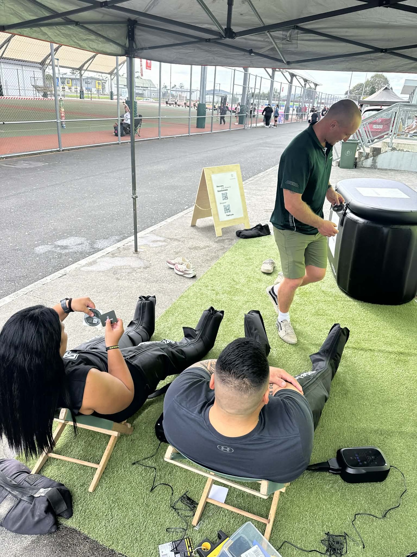 People lying back in compression boots at the recovery zone