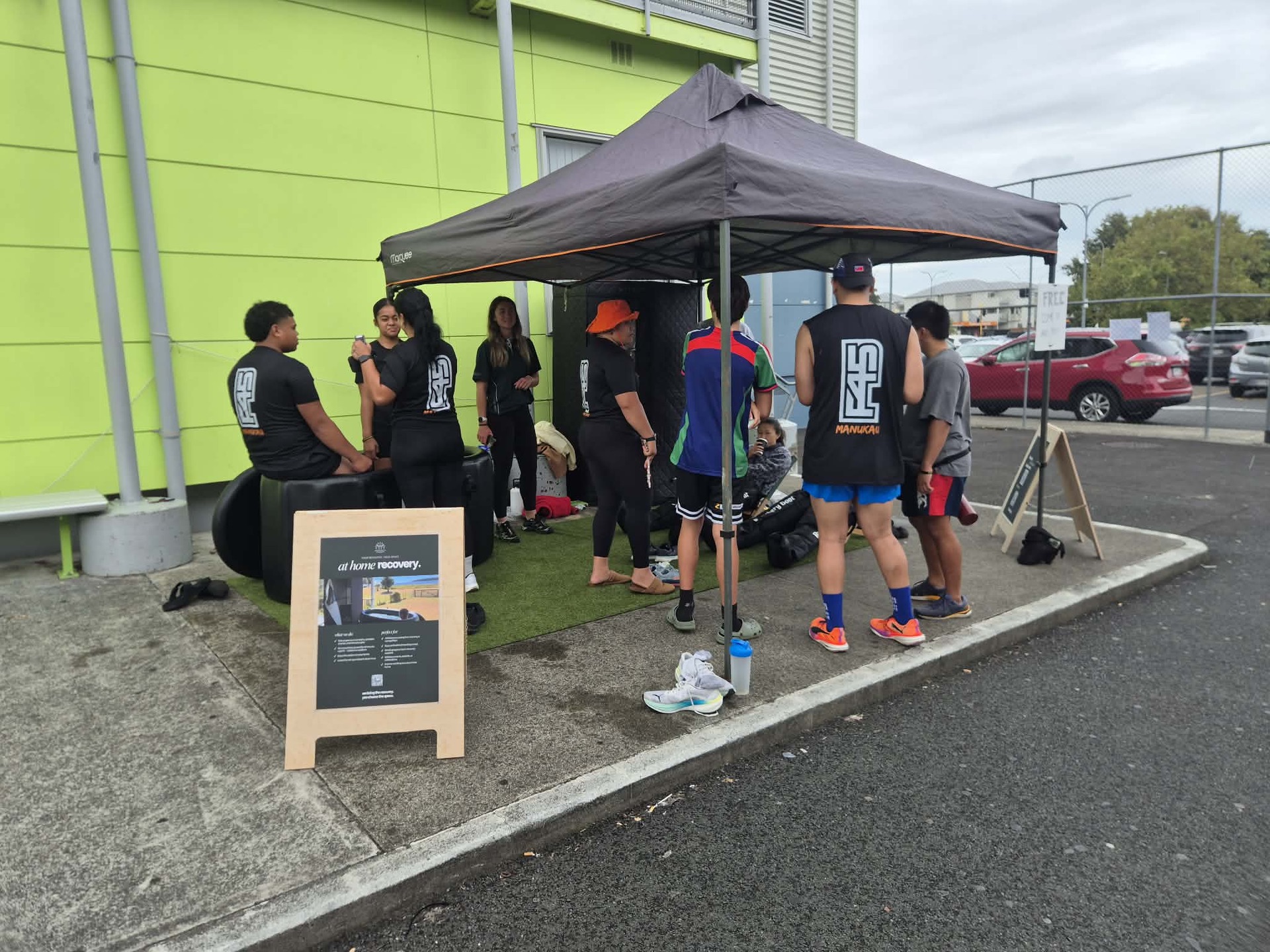 The At Home Recovery set-up at an event, with signage out front